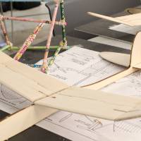 A wooden plane being built by a student